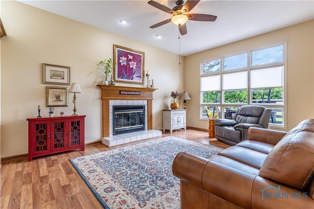 6666 Brick Yard Ct, Maumee, OH 43537 - living area featuring a ceiling fan, a tile fireplace, and light wood-style flooring
