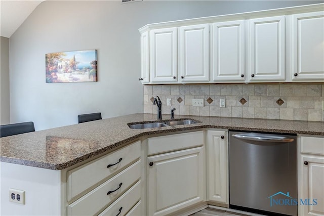 6666 Brick Yard Ct, Maumee, OH 43537 - kitchen featuring stainless steel dishwasher, decorative backsplash, a peninsula, dark stone counters, and white cabinetry