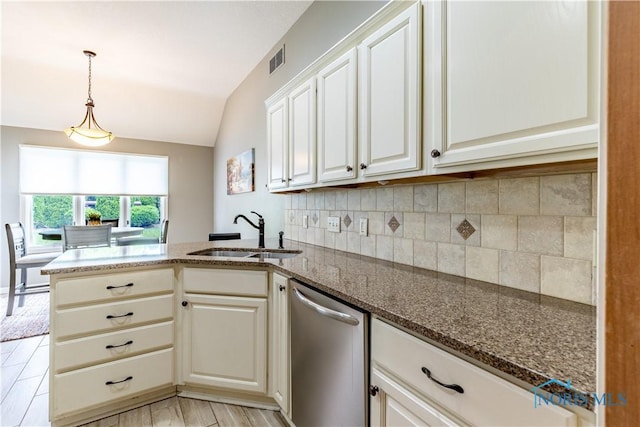 6666 Brick Yard Ct, Maumee, OH 43537 - kitchen featuring dishwasher, tasteful backsplash, a peninsula, dark stone countertops, and lofted ceiling