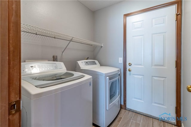 6666 Brick Yard Ct, Maumee, OH 43537 - laundry room with washing machine and clothes dryer and light wood-type flooring