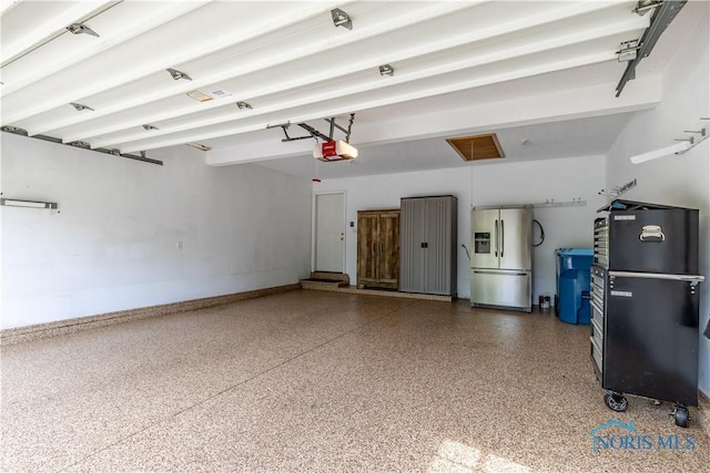 6666 Brick Yard Ct, Maumee, OH 43537 - garage with stainless steel fridge with ice dispenser, freestanding refrigerator, and a garage door opener