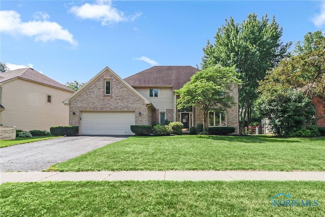 7257 Wembley Ter, Toledo, OH 43617 - traditional-style home with brick siding, driveway, a front yard, and a garage