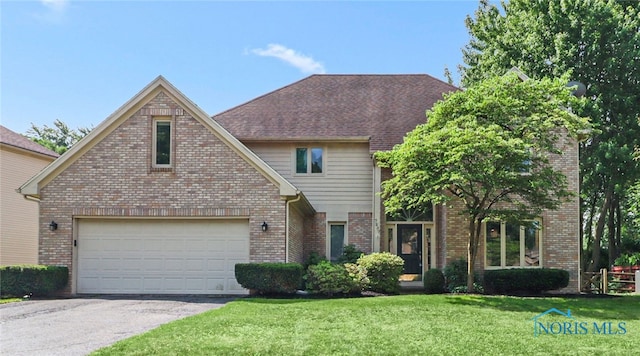 7257 Wembley Ter, Toledo, OH 43617 - traditional-style home featuring brick siding, a front yard, and asphalt driveway