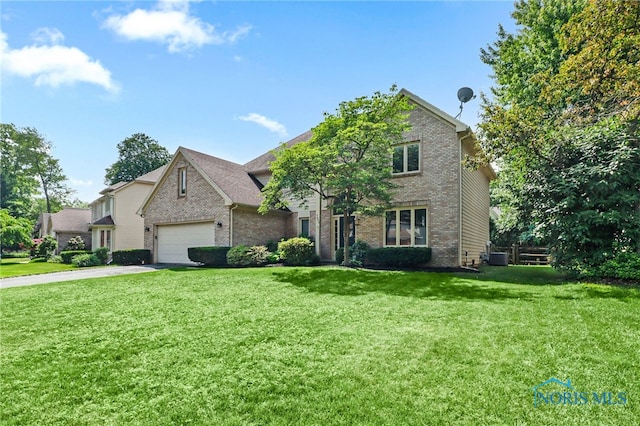 7257 Wembley Ter, Toledo, OH 43617 - traditional home with brick siding, driveway, a front yard, and an attached garage