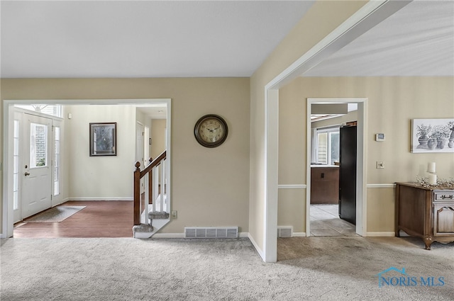 7257 Wembley Ter, Toledo, OH 43617 - entryway featuring plenty of natural light, carpet floors, and stairs