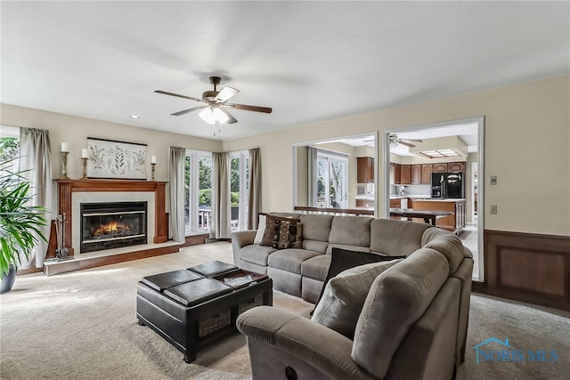 7257 Wembley Ter, Toledo, OH 43617 - living room with ceiling fan, plenty of natural light, light colored carpet, and wainscoting