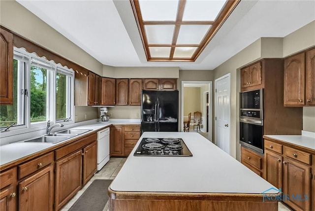 7257 Wembley Ter, Toledo, OH 43617 - kitchen with black fridge, electric cooktop, oven, dishwasher, and a center island