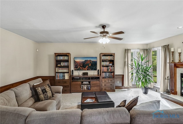 7257 Wembley Ter, Toledo, OH 43617 - carpeted living room with a ceiling fan and a fireplace with raised hearth