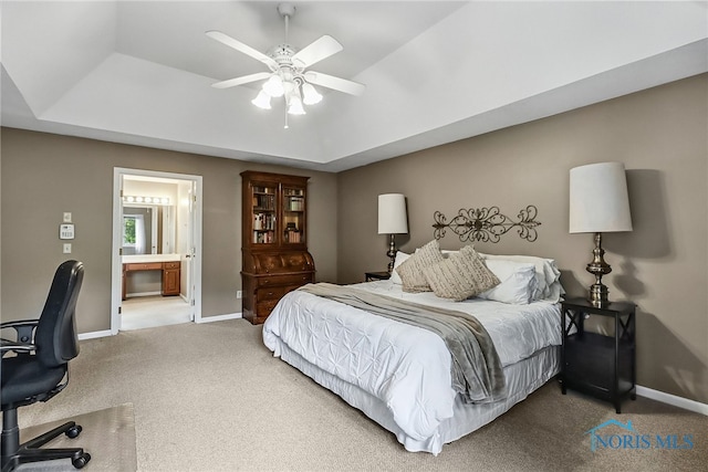 7257 Wembley Ter, Toledo, OH 43617 - bedroom with an office area, a raised ceiling, carpet, connected bathroom, and a ceiling fan