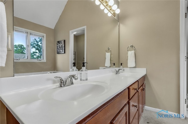 7257 Wembley Ter, Toledo, OH 43617 - bathroom featuring double vanity and vaulted ceiling
