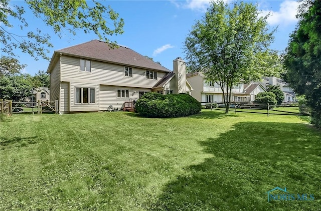7257 Wembley Ter, Toledo, OH 43617 - back of house with a fenced backyard and a chimney
