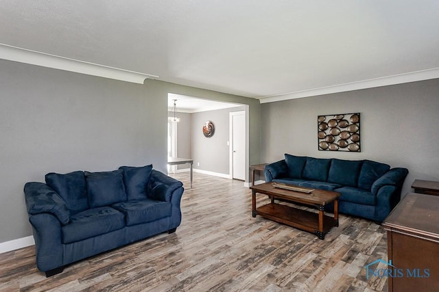 2338 Greenlawn Dr, Toledo, OH 43614 - living area featuring wood finished floors, crown molding, and a chandelier