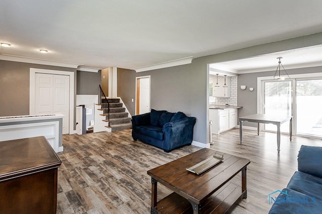 2338 Greenlawn Dr, Toledo, OH 43614 - living room featuring stairway, ornamental molding, and wood finished floors