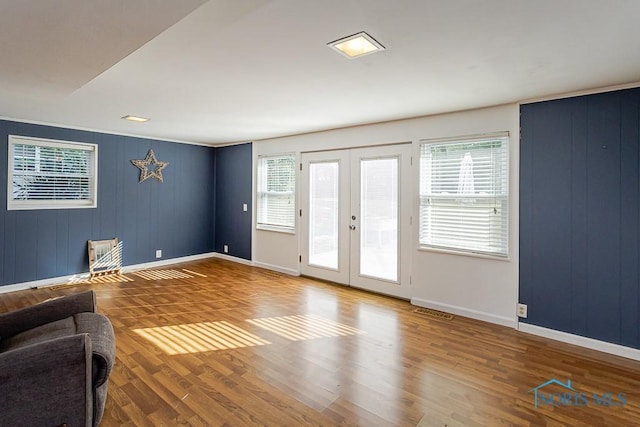 2338 Greenlawn Dr, Toledo, OH 43614 - unfurnished living room with healthy amount of natural light, wood finished floors, and french doors