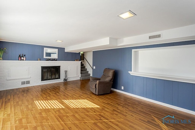 2338 Greenlawn Dr, Toledo, OH 43614 - unfurnished room with a fireplace, wood finished floors, stairs, and a decorative wall