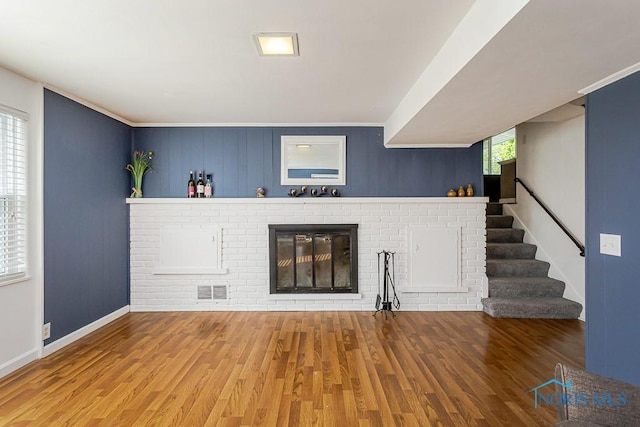 2338 Greenlawn Dr, Toledo, OH 43614 - unfurnished living room with wood finished floors, a fireplace, and stairway