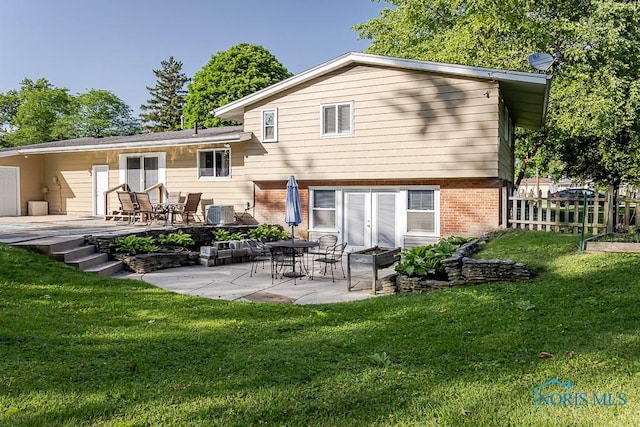 2338 Greenlawn Dr, Toledo, OH 43614 - back of property with brick siding and a patio
