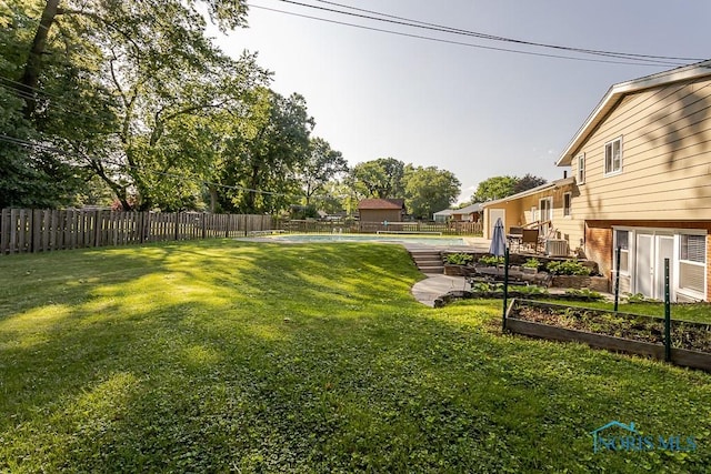 2338 Greenlawn Dr, Toledo, OH 43614 - fenced backyard featuring a vegetable garden