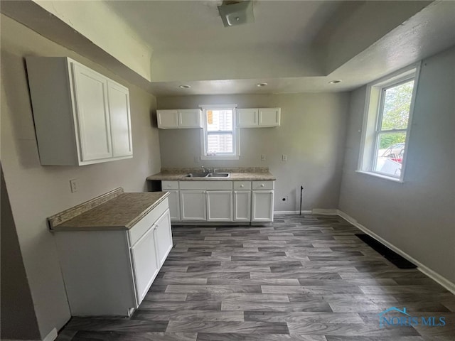 1131 Montrose Ave, Toledo, OH 43607 - kitchen with plenty of natural light, wood finished floors, white cabinetry, recessed lighting, and a raised ceiling
