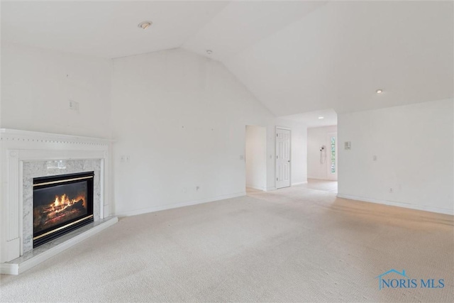 26332 Whitewater Dr, Perrysburg, OH 43551 - unfurnished living room featuring lofted ceiling, a high end fireplace, light colored carpet, and recessed lighting