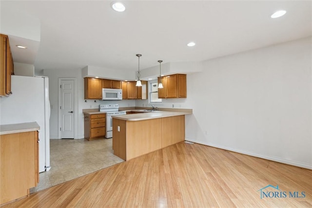 26332 Whitewater Dr, Perrysburg, OH 43551 - kitchen with white appliances, a peninsula, light countertops, light wood-style flooring, and recessed lighting