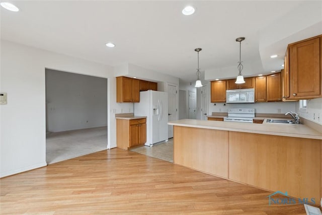 26332 Whitewater Dr, Perrysburg, OH 43551 - kitchen featuring white appliances, a peninsula, light wood-style floors, light countertops, and pendant lighting