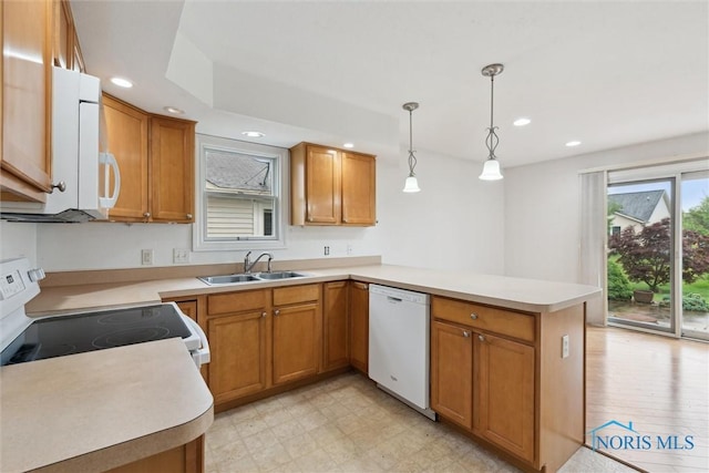 26332 Whitewater Dr, Perrysburg, OH 43551 - kitchen with white appliances, a peninsula, recessed lighting, brown cabinetry, and decorative light fixtures