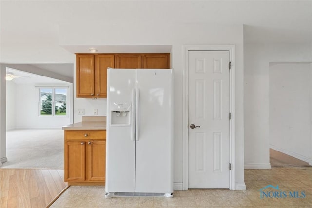 26332 Whitewater Dr, Perrysburg, OH 43551 - kitchen with white fridge with ice dispenser, brown cabinets, and light countertops