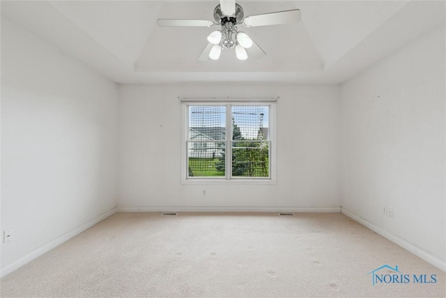 26332 Whitewater Dr, Perrysburg, OH 43551 - empty room with a tray ceiling, carpet, and ceiling fan