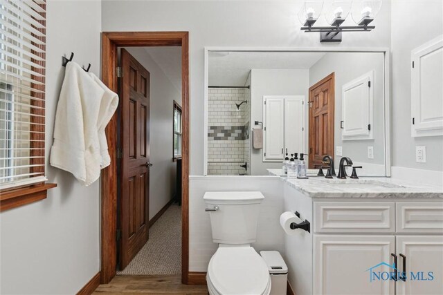 824 Edgehill Rd, Findlay, OH 45840 - bathroom with vanity, a tile shower, wood finished floors, and a chandelier
