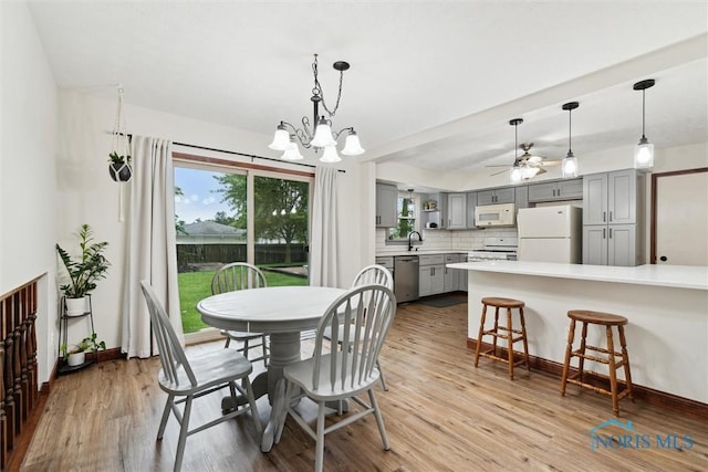 824 Edgehill Rd, Findlay, OH 45840 - dining room featuring light wood finished floors, healthy amount of natural light, a chandelier, and a ceiling fan
