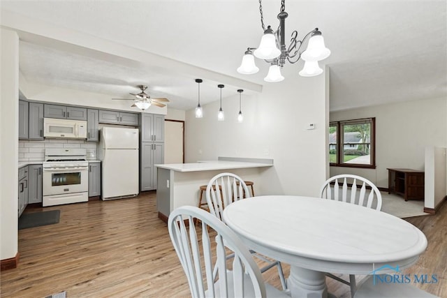 824 Edgehill Rd, Findlay, OH 45840 - dining area with wood finished floors, a chandelier, and ceiling fan