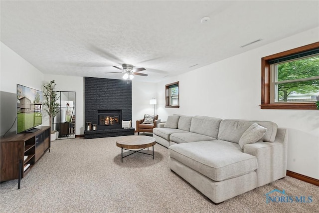 824 Edgehill Rd, Findlay, OH 45840 - carpeted living room featuring a ceiling fan, a brick fireplace, and a textured ceiling