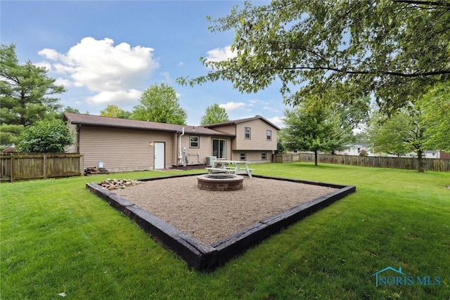 824 Edgehill Rd, Findlay, OH 45840 - back of property featuring an outdoor fire pit and a fenced backyard