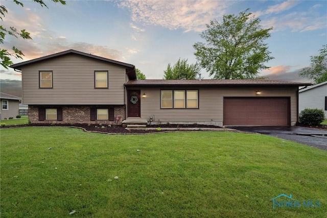 824 Edgehill Rd, Findlay, OH 45840 - split level home with asphalt driveway, a lawn, and an attached garage