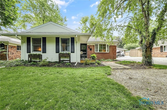550 W 2nd St, Perrysburg, OH 43551 - view of front of property featuring a porch, a front yard, driveway, and brick siding