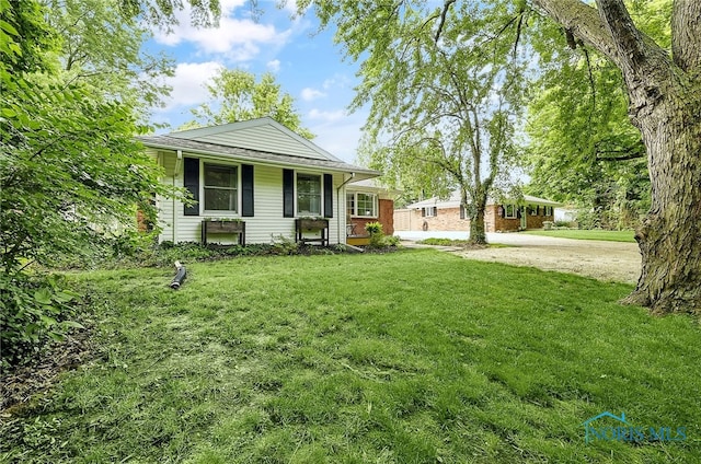 550 W 2nd St, Perrysburg, OH 43551 - view of front facade featuring a front lawn and driveway