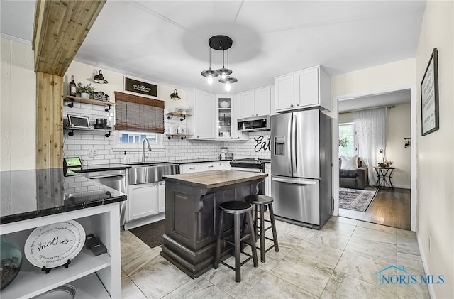 550 W 2nd St, Perrysburg, OH 43551 - kitchen featuring stainless steel appliances, open shelves, backsplash, white cabinets, and butcher block counters