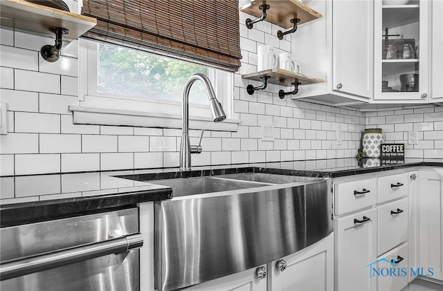 550 W 2nd St, Perrysburg, OH 43551 - kitchen with dark countertops, open shelves, white cabinetry, and backsplash
