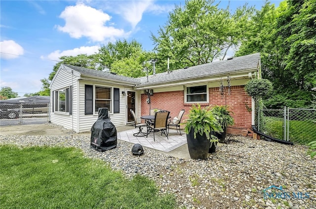 550 W 2nd St, Perrysburg, OH 43551 - rear view of property with a patio area, brick siding, a gate, and a shingled roof
