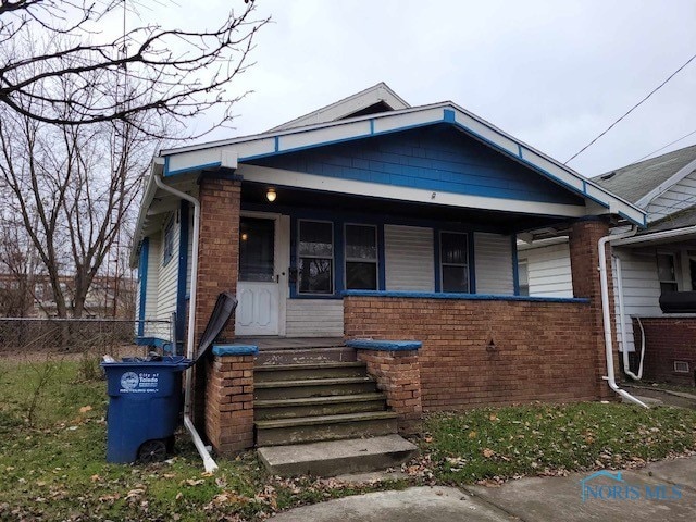 728 Ashwood Ave, Toledo, OH 43608 - view of front facade featuring covered porch and brick siding