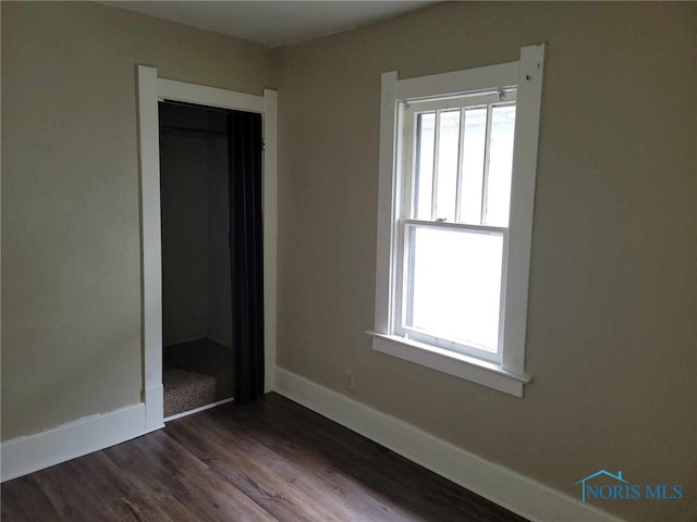728 Ashwood Ave, Toledo, OH 43608 - unfurnished bedroom with dark wood-style floors and a closet