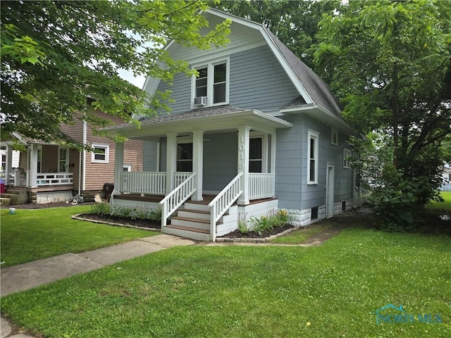 1019 Wayne Ave, Defiance, OH 43512 - view of front facade featuring a porch, a shingled roof, a gambrel roof, and a front yard