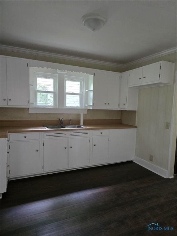 1019 Wayne Ave, Defiance, OH 43512 - kitchen featuring crown molding, white cabinets, and dark wood-style flooring