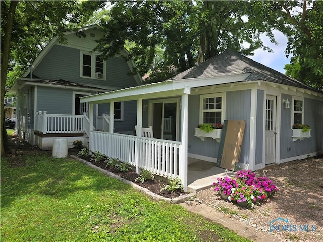 1019 Wayne Ave, Defiance, OH 43512 - view of front of home with a porch, a front lawn, and a shingled roof