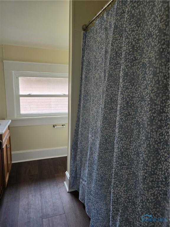 1019 Wayne Ave, Defiance, OH 43512 - full bathroom featuring hardwood / wood-style floors, vanity, and a shower with curtain