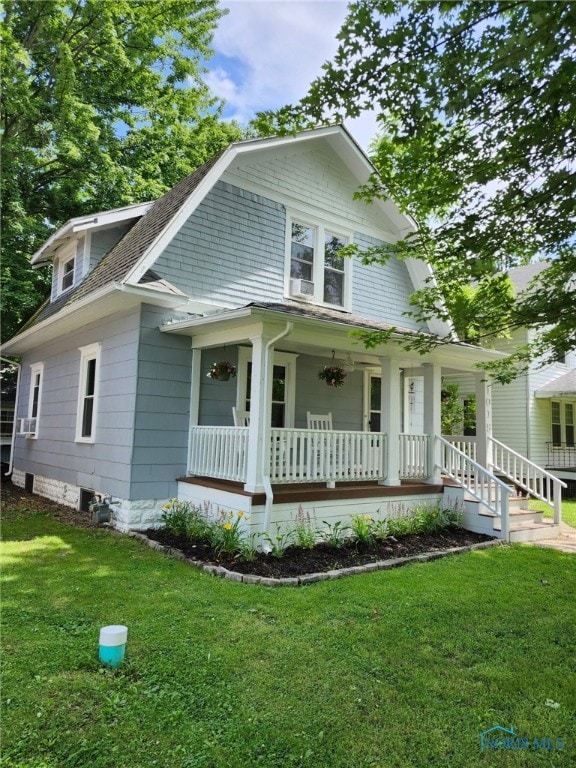 1019 Wayne Ave, Defiance, OH 43512 - view of front of house featuring covered porch, a front lawn, and a shingled roof