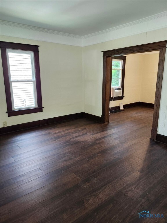 1019 Wayne Ave, Defiance, OH 43512 - spare room with ornamental molding, dark wood-type flooring, and cooling unit