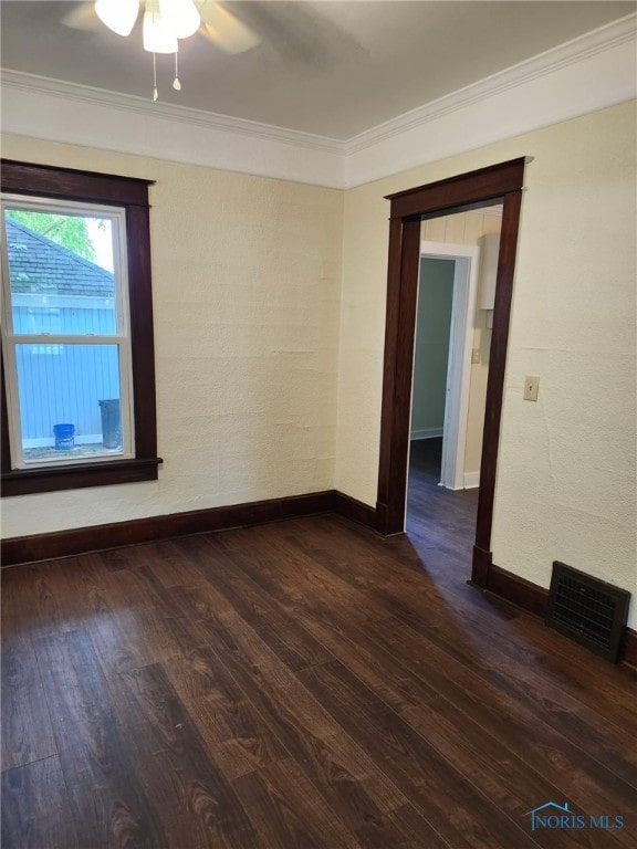 1019 Wayne Ave, Defiance, OH 43512 - spare room featuring crown molding, dark wood-style floors, and ceiling fan
