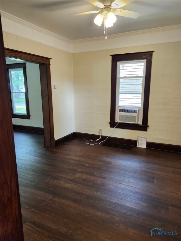 1019 Wayne Ave, Defiance, OH 43512 - empty room with ornamental molding, dark wood finished floors, ceiling fan, and cooling unit